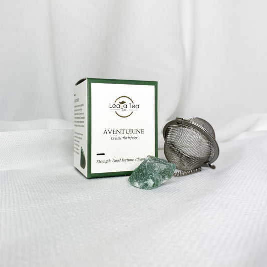 Athella Aventurine Crystal Tea Infuser, Strength, Good Fortune, Cleanse box packaging next to round tea strainer with aventurine on end of chain.