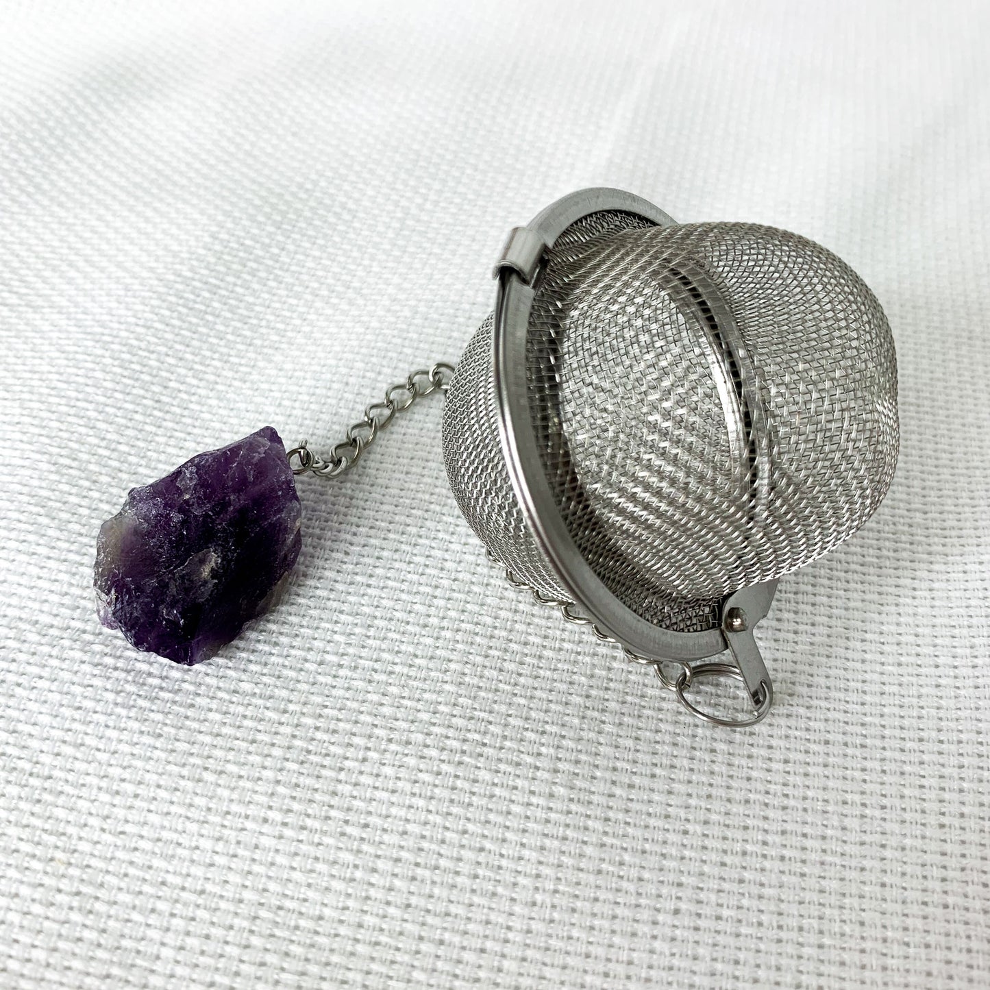 Amethyst round shaped Crystal Tea Infuser with natural amethyst crystal on end. 