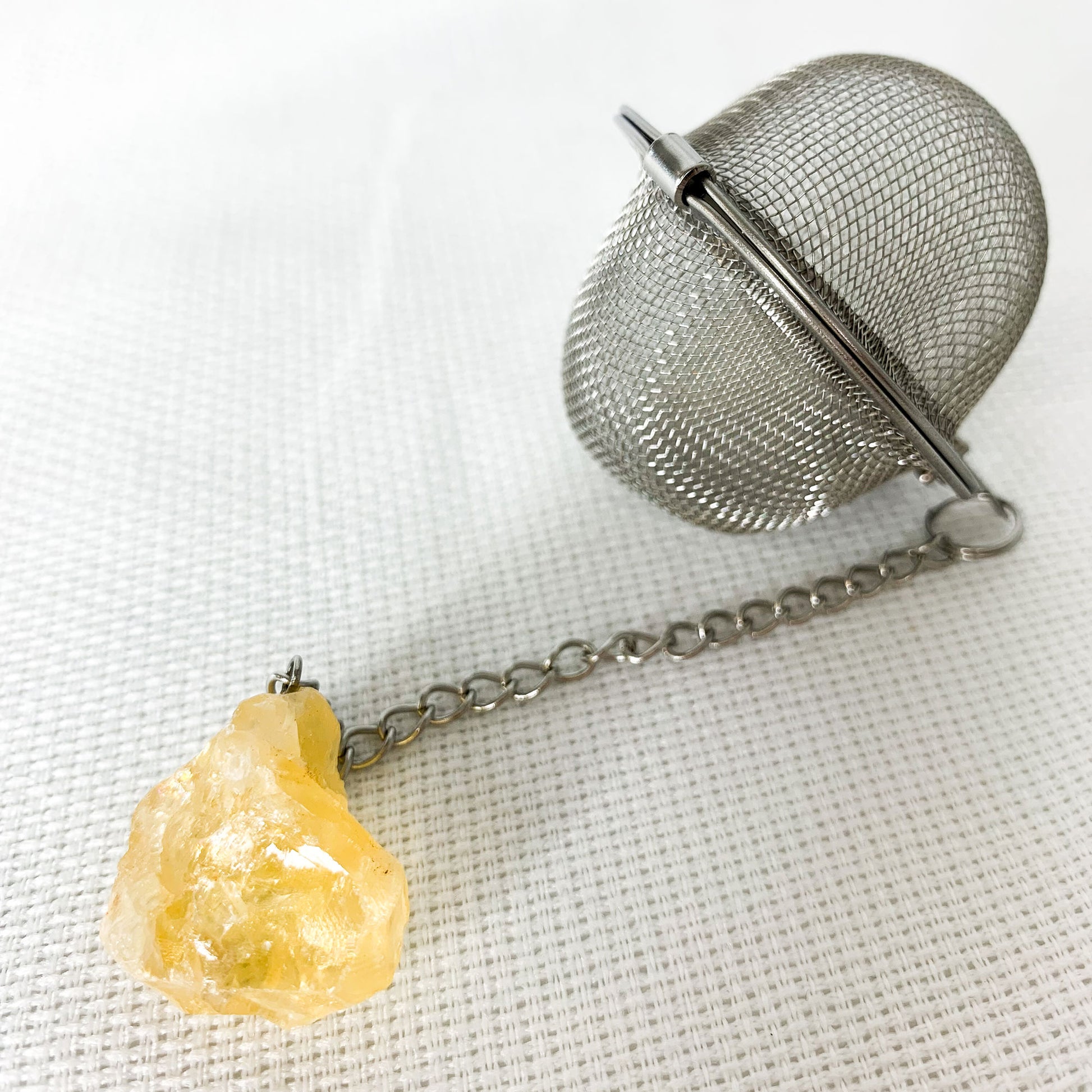 Round Citrine Crystal Tea Infuser with natural citrine crystal at end of chain.