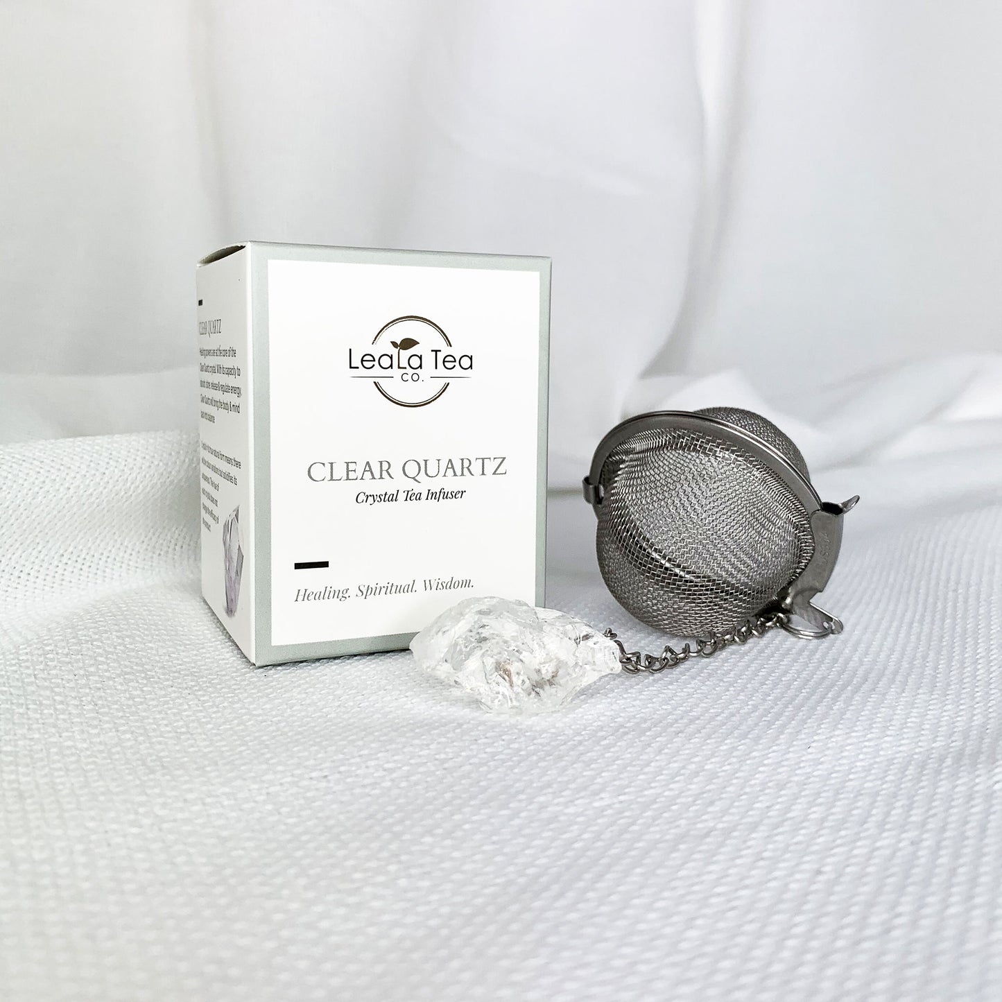Athella Clear Quartz Crystal Tea Infuser, Healing, Spiritual, Wisdom box packaging next to round Clear Quartz Crystal Infuser.