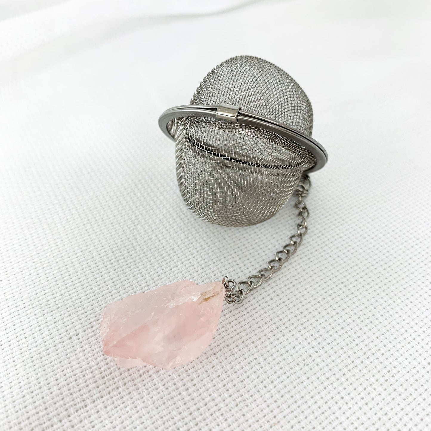 Round tea infuser with natural Rose Quartz crystal at end of chain.